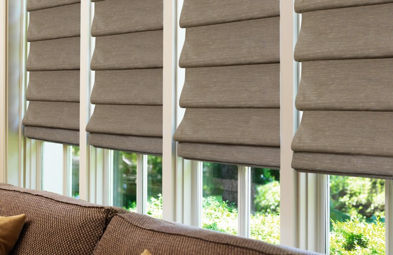 Roman shades covering window in sunroom